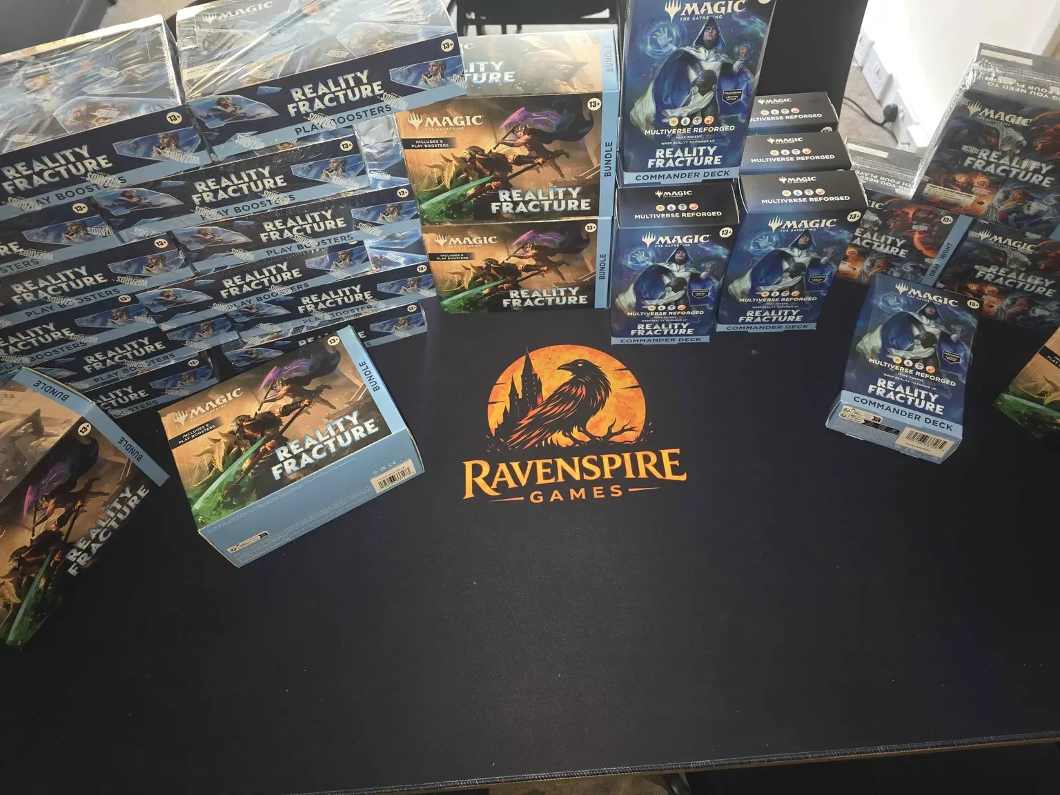 Complete Magic: The Gathering Reality Fracture product lineup on Ravenspire Games playmat